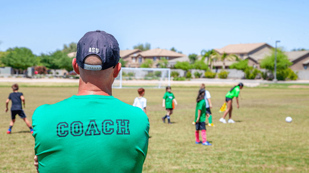 Coach looking his soccer player 