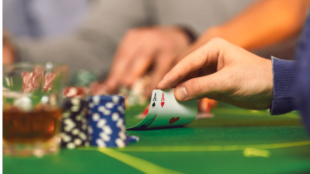 Holding Playing cards and casino chips 
